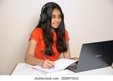 Mumbai Maharashtra India Asia April 25 2021 Little Indian Teen Girl Sit Comfort Cozy Table Desk Study Remote Use Laptop Online Teacher Communication Chatting Have Headset In House Indoors