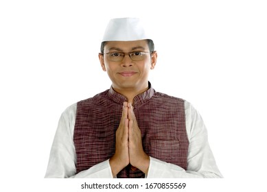 Mumbai; Maharashtra; India- Asia; Dec. 26, 2009 -Indian young handsome politician greeting traditional welcome pose namaste on white background