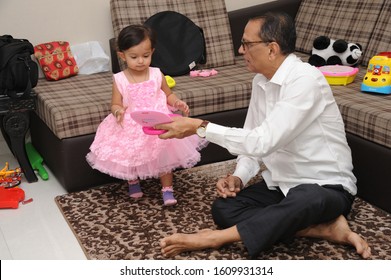 Mumbai, Maharashtra, India- Asia, Jan. 28, 2018 - Indian Happy Family Grand Father Playing With Grand Daughter.   