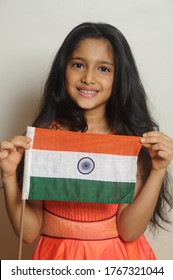 Mumbai, Maharashtra, India, Asia, June. 27, 2020 - Cute Little Girl With Indian National Tricolour Flag, Celebrating Independence Or Republic Day Girl In Traditional Dress With Long Hair    