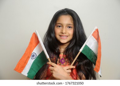 Mumbai, Maharashtra, India, Asia, June. 27, 2020 - Cute Little Girl With Indian National Tricolour Flag, Celebrating Independence Or Republic Day Girl In Traditional Dress With Long Hair    