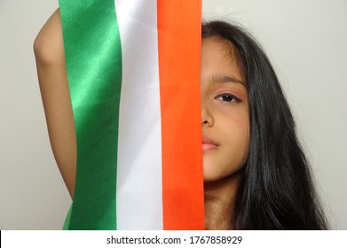 Mumbai, Maharashtra, India, Asia, June. 27, 2020 - Cute Little Girl With Indian National Tricolour Flag, Celebrating Independence Or Republic Day Girl In Traditional Dress With Long Hair    