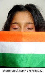 Mumbai, Maharashtra, India, Asia, June. 27, 2020 - Cute Little Girl With Indian National Tricolour Flag, Celebrating Independence Or Republic Day Girl In Traditional Dress With Long Hair    