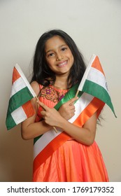 Mumbai, Maharashtra, India, Asia, June. 27, 2020 - Cute Little Girl With Indian National Tricolour Flag, Celebrating Independence Or Republic Day Girl In Traditional Dress With Long Hair    