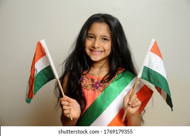 Mumbai, Maharashtra, India, Asia, June. 27, 2020 - Cute Little Girl With Indian National Tricolour Flag, Celebrating Independence Or Republic Day Girl In Traditional Dress With Long Hair  