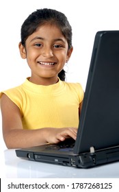 Mumbai, Maharashtra, India- Asia, June. 07, 2008 - Educational Software For Student Indian Asian Little Cute Girl Studying Using Laptop Technology Education At Home Concept On White Background