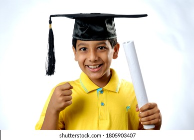 Mumbai; Maharashtra; India; Asia; June. 06; 2008 - Portrait of Beautiul Indian nine years old cute little boy in graduation cap, master's degree, a bachelor lawyer / judge