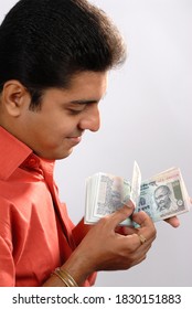 Mumbai, Maharashtra, India, Asia, Sept. 11, 2007 - Indian Businessman Counting A Batch Of One Hundred Rupee Notes Concept For Money Counting; Salary; Payment And Funds Background.