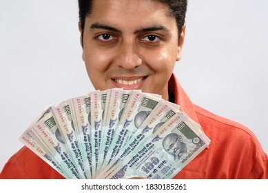 Mumbai, Maharashtra, India, Asia, Sept. 11, 2007 - Indian Businessman Showing A Batch Of One Hundred Rupee Notes Concept For Money Counting; Salary; Payment And Funds Background.