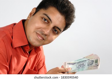 Mumbai, Maharashtra, India, Asia, Sept. 11, 2007 - Indian Businessman Counting A Batch Of One Hundred Rupee Notes Concept For Money Counting; Salary; Payment And Funds Background.