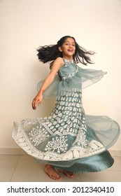 Mumbai Maharashtra India July 20, 2021, Full-length Slow Motion Portrait Of A Young Beautiful Little Indian Girl Wearing An Elegant Sea Green Gown 