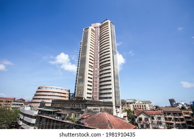 MUMBAI, MAHARASHTRA, INDIA : June 01, 2011 : A Man Doing Water Proofing On The Roof Of Old Buildings Before Rain Starts In The South Mumbai Near Stock Exchange Building, MUMBAI, MAHARASHTRA, INDIA