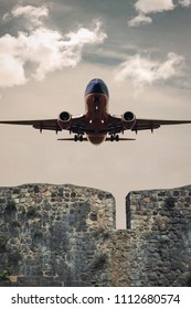 Mumbai, Maharashtra, India - June 1, 2018 : Airplane Take Off From Behind A Stone Wall