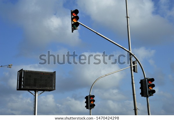 Mumbai; Maharashtra; India -May 11; 2012 :\
Traffic lights turning green and red under the blue sky. All\
vehicles must stop with red light. Cars can go with green light.\
Red stoplight on the\
street.\
\
