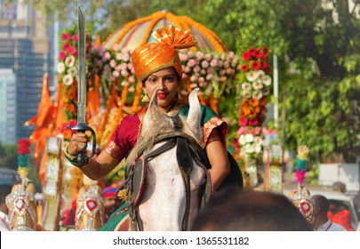 Mumbai, Maharashtra/India - April 6, 2019 : A Young Girl Dressed Up As Rani Lakshmi Bai With A Sword, Riding The Horse, Leading The Procession Of People, Celebrating Gudi Padwa/Ugadi