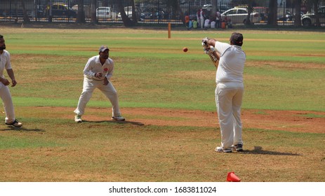 Mumbai, Maharastra/India- March 26 2020: An Adult Man Is Playing Cricket With His Colleagues.