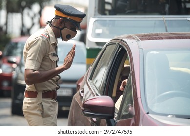 MUMBAI-INDIA - April 10, 2021: Policemen stop motorists at a checkpoint during weekend lockdown restrictions imposed by the state government amidst rising Covid-19 coronavirus cases, in Mumba.
