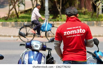 Mumbai/India - April 6, 2019 : Delivery Boy Of Zomato, One Of The Leading Online Food Delivery Startup In The Food-tech Space, Waiting To Pick Up Order In Hiranandani, Powai #StayHomeStaySafe