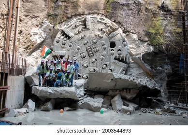 MUMBAI-INDIA - February 12, 2021: Mumbai Metro Corporation worker waves an Indian national flag after tunnel boring machine reaches the breakthrough point of the tunnel on Mumbai Metro Line-3.