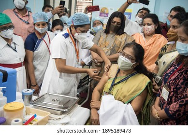 MUMBAI-INDIA - January 16, 2021: A medical worker inoculates Vidya Thakur (R), medical dean of the Rajawadi Hospital, with a Covid-19 coronavirus vaccine at the hospital