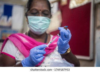 MUMBAI/INDIA- JUNE 23, 2020: A Medical Worker Prepare An Injection Of Vaccine During A Vaccination Drive At A Community Healthcare Centre.