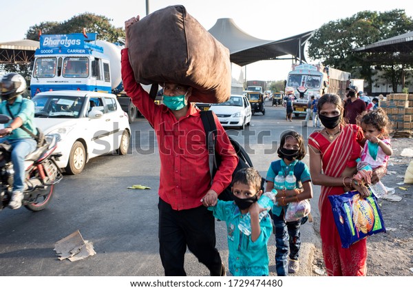 MUMBAI/INDIA - MAY 11, 2020:\
Migrant workers walk on the highway on their journey back home\
during a nationwide lockdown to fight the spread of the COVID-19\
coronavirus.