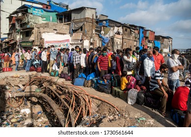 MUMBAI/INDIA - MAY 13, 2020: Migrant Workers Stand In Queue At Railway Terminus For Boarding A Special Train Back Home During A Nationwide Lockdown.