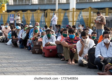 MUMBAI/INDIA - MAY 21, 2020: Migrant Workers Sits In Queues At Railway Terminus For Boarding A Special Train Back Home During A Nationwide Lockdown.