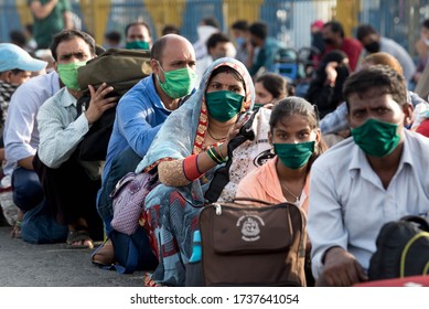 MUMBAI/INDIA - MAY 21, 2020: Migrant Workers Sits In Queues At Railway Terminus For Boarding A Special Train Back Home During A Nationwide Lockdown.