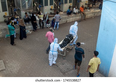 MUMBAI/INDIA- MAY 30, 2020: Hospital staff carry the body of a person who died of COVID-19 to a morgue at Sion hospital