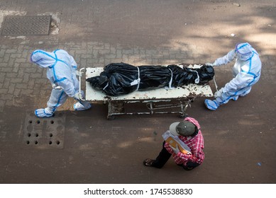 MUMBAI/INDIA- MAY 30, 2020: Hospital staff carry the body of a person who died of COVID-19 to a morgue at Sion hospital