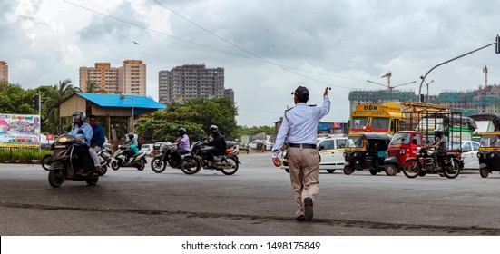 Mumbai,India,8-21-2019:A traffic police patrolling vehicular traffic at a traffic signal in Mumbai . New motor vehicle act causing problems for traffic cop