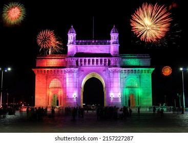Mumbai's iconic historical landmark Gateway of India beautifully illuminared colorfully and with fireworks on special occasion or festivals. Copy space.