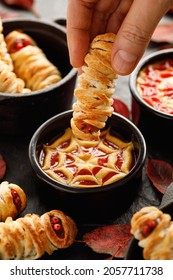 Mummy Dogs Dipped In Ketchup And Mustard Sauce, Close Up View. Halloween Funny Food Idea For Party 