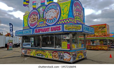 Muncie, Indiana - United States - 4-16-21 - Colorful Carnival Food Booth With Flags And Overcast Sky