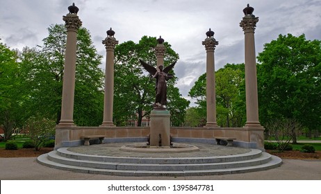 Muncie, Indiana / United States - May10, 2019  Ball State University Beneficence Statue With Trees And Overcast Sky.