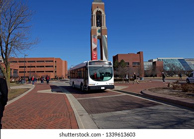 MUNCIE, IN - MARCH 2019: A Bus Is In The Foreground Of An Image At Ball State University.  