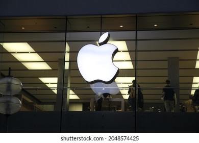 Munich, Bavaria, Germany - 12.20.2021:  Apple Store Front With Iluminated Apple Loge By Night.