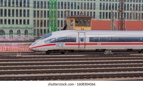 MUNICH, BAVARIA / GERMANY - December 14, 2019: Side View On Intercity Express Train Of Deutsche Bahn (ICE). In The Foreground Rail Tracks, In The Background Buildings. Fast, Convenient & Ecological.