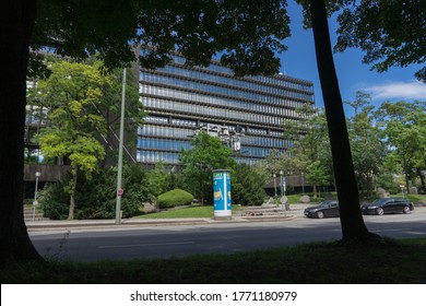 Munich, Bavaria / Germany - July 05, 2020: building of the "European Patent Office", in front an advertising pillar with poster advertising for cigarettes