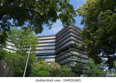 Munich, Bavaria, Germany - July 05, 2020: building of the "European Patent Office", in front framed by the leaf of green trees