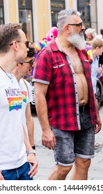 MUNICH, BAVARIA / GERMANY - JULY 14, 2018: An Older Obese Man And Other People Attending The Gay Pride Parade Also Known As Christopher Street Day (CSD) In Munich, Germany. 