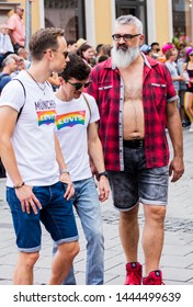 MUNICH, BAVARIA / GERMANY - JULY 14, 2018: An Older Obese Man And Other People Attending The Gay Pride Parade Also Known As Christopher Street Day (CSD) In Munich, Germany. 