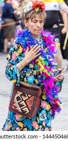 MUNICH, BAVARIA / GERMANY - JULY 14, 2018: An Older Woman In A Colorful Dress With Feathers Attending The Gay Pride Parade Also Known As Christopher Street Day (CSD) In Munich, Germany. 