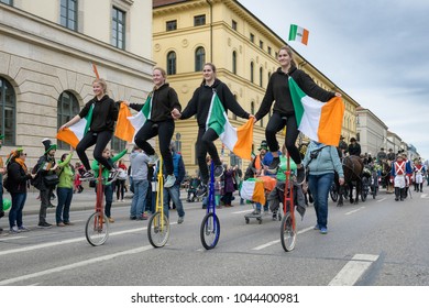 MUNICH, BAVARIA, GERMANY -  MARCH 11, 2018: Group Of Girls On Acrobatic Unicycle At The St. Patrick's Day Parade.