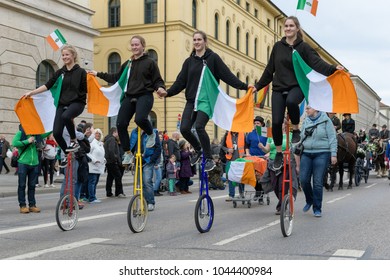 MUNICH, BAVARIA, GERMANY -  MARCH 11, 2018: Group Of Girls On Acrobatic Unicycle At The St. Patrick's Day Parade.