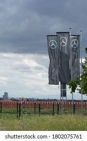 Munich, Bavaria/Germany - August 23, 2020: Flags With Mercedes-Benz Logo Beside A Car Dealer Building, Cloudy Sky. Mercedes-Benz Is A Global Auto Brand, A Division Of The German Company Daimler AG