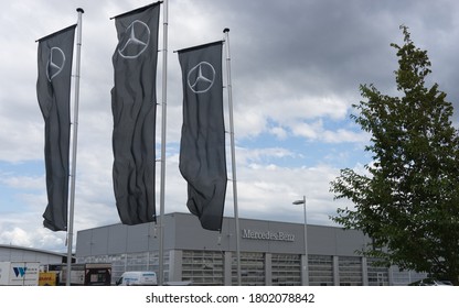 Munich, Bavaria/Germany - August 23, 2020: Flags With Mercedes-Benz Logo In Front Of A Car Dealer Building With Logo. Mercedes-Benz Is A Global Auto Brand, A Division Of The German Company Daimler AG