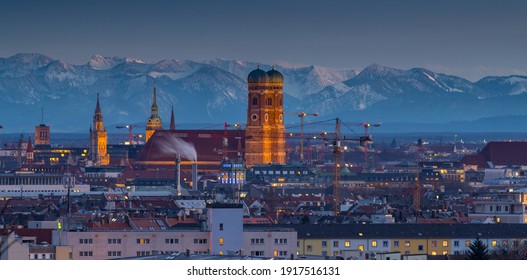 Munich City At Night Skyline Aerial View Frauenkirche Church Alps Mountains, Germany.