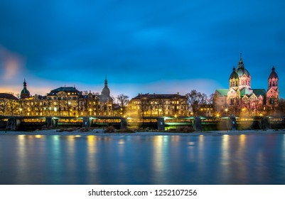 Munich Cytiscape Skyline View, Isar River And St. Luke's Church At Night In Munich. Saint Lucas Churchis The Largest Protestant Church In Munich